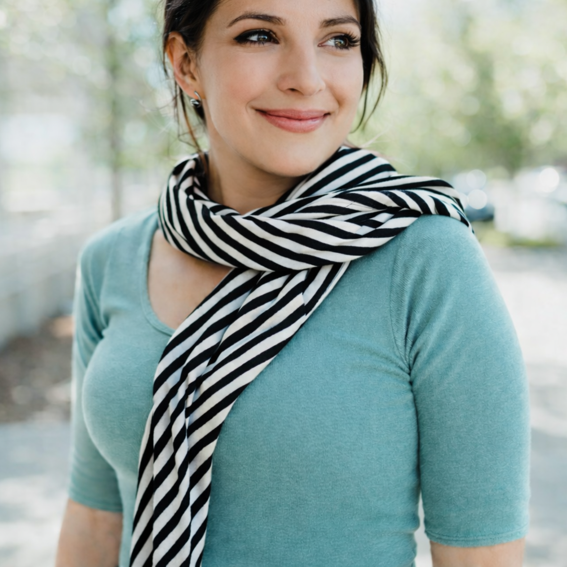 Woman wearing a black and white striped scarf outdoors