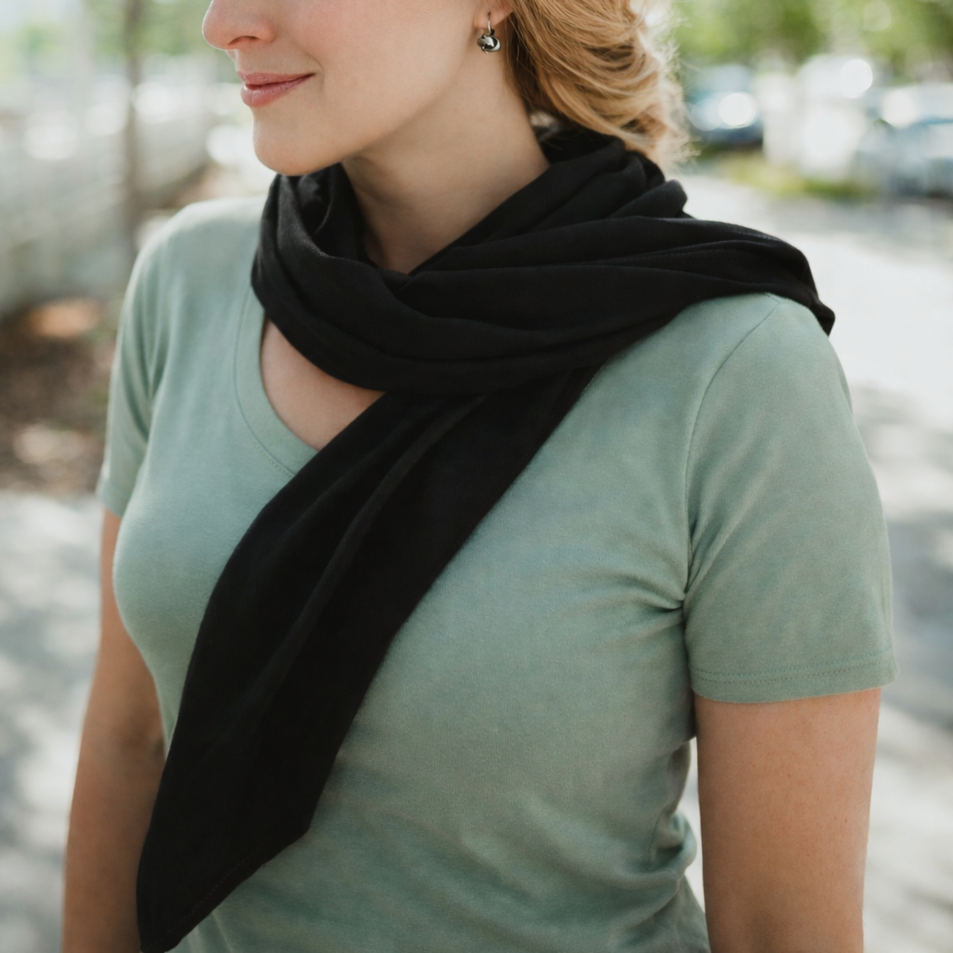 Mom wearing a black scarf multi-purpse baby item