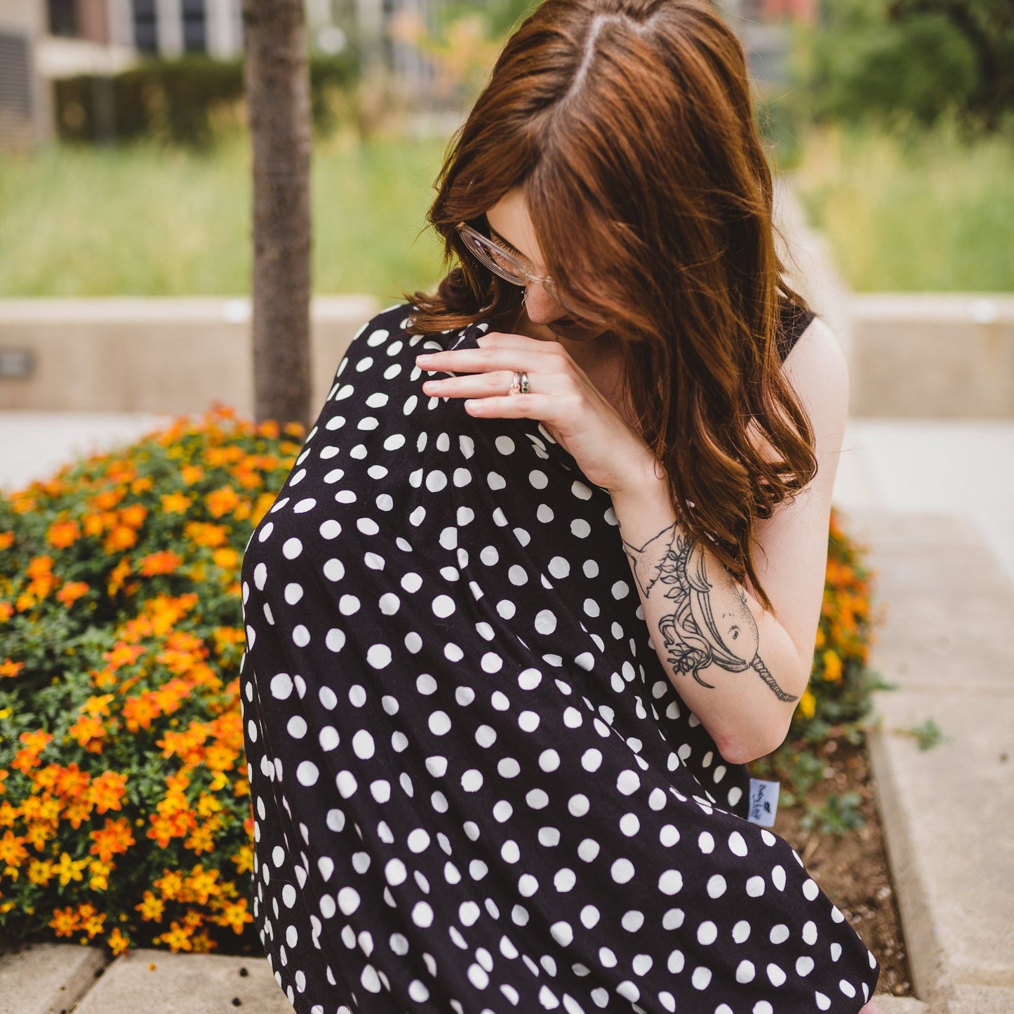 Mom with baby and full coverage polka dot nursing cover 