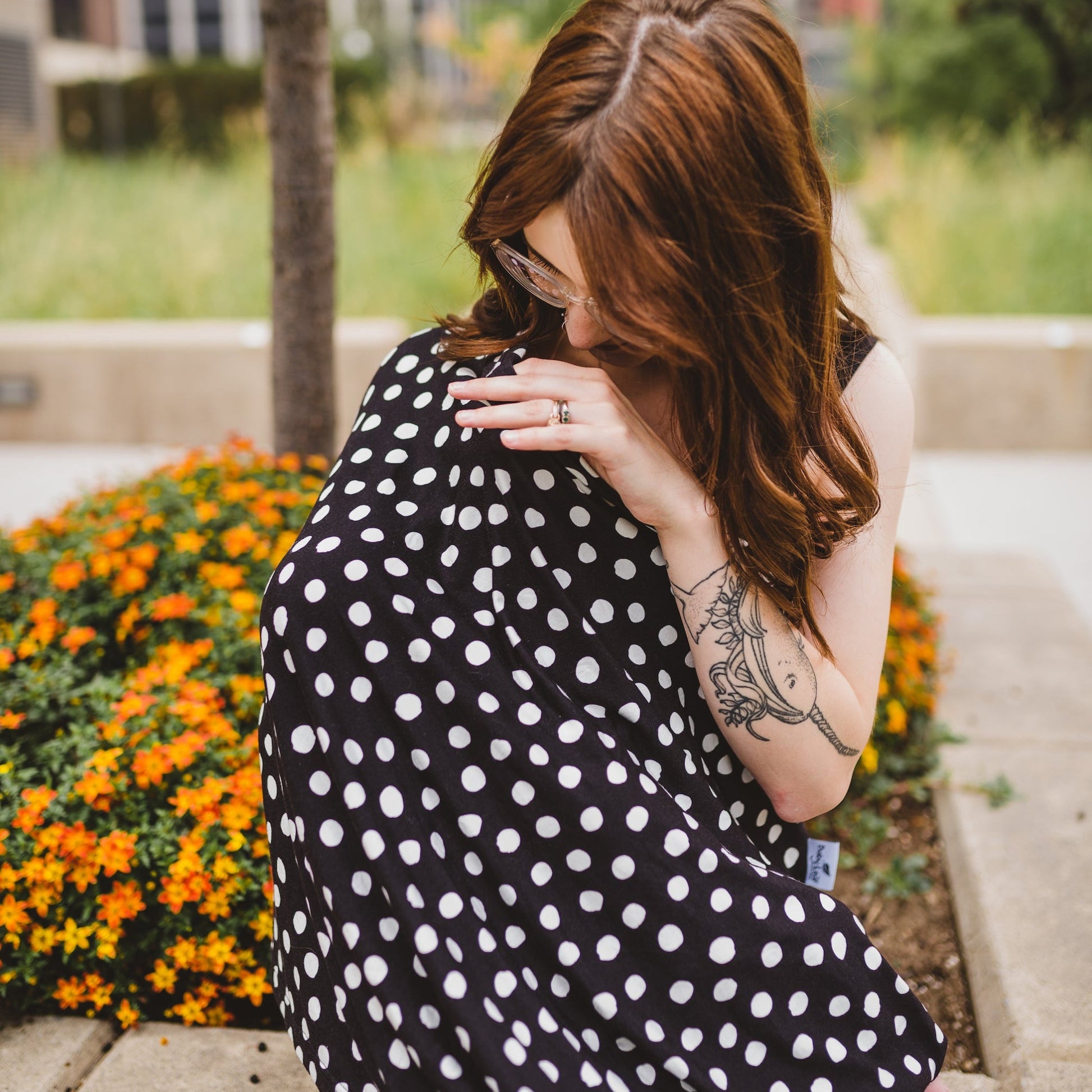 Mom with baby and full coverage polka dot nursing cover 